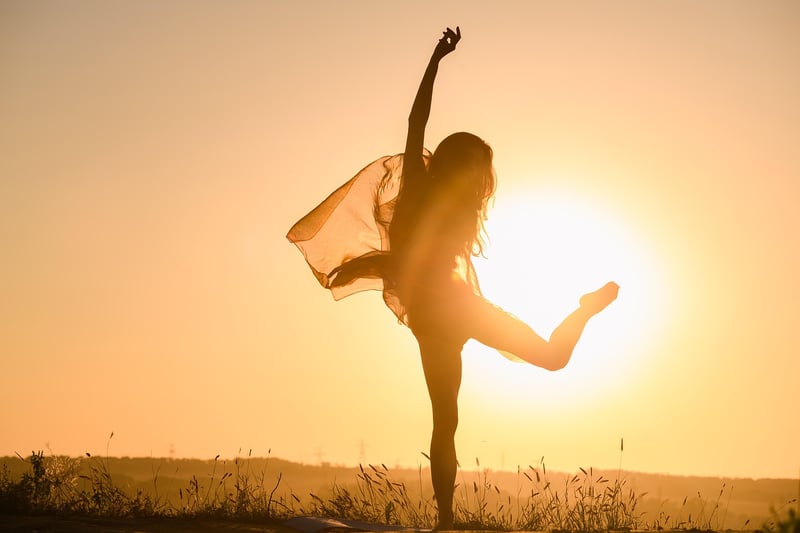 Woman practicing breathwork at sunset